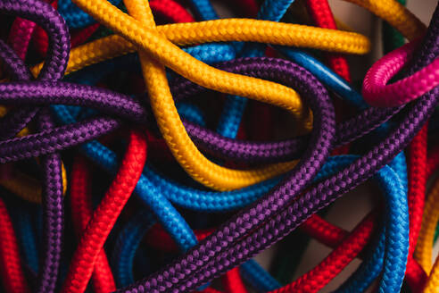 From above of messy mixed colorful shoelaces - ADSF44973