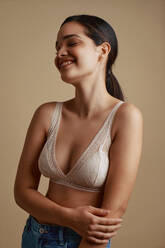Woman in pink bras with t-shirt over face smiling stock photo