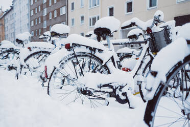 Bike at snowbound†parking placed near townhouses in winter London - ADSF45174