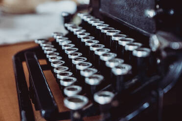 Closeup shot of shabby keys of retro typewriter standing on desk - ADSF45190