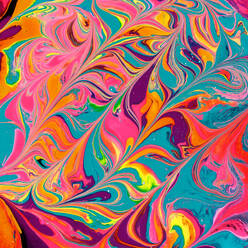 Close-up shot of thick paint of various bright colors flowing down and mixing together - ADSF45191