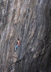 Woman climbing mountain with rope - ALRF02093