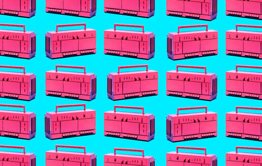 Pattern of set of similar pink retro tape recorder against blue backdrop as abstract background - ADSF45207