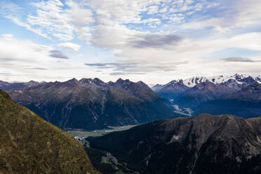 Picturesque scenery of massive rocky mountains with snowy peaks under cloudy sky in Swiss Alps - ADSF45420