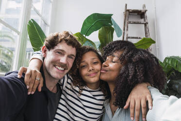 A joyful family captures a moment together in a winter garden with a fun selfie - PNAF05694