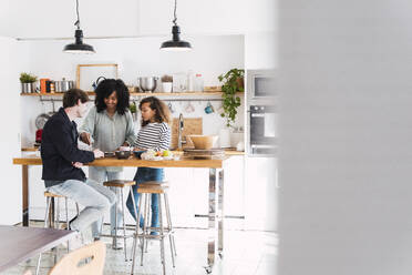 Family in kitchen preparing food together - PNAF05733