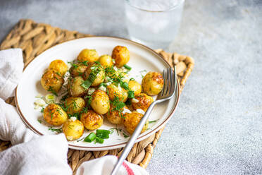 Fried spring potato vegetables with herbs served in the bowl for lunch - ADSF45460