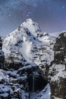 Picturesque view of Urbasa Range covered with snow under majestic starry sky during winter trip through Spain - ADSF45543