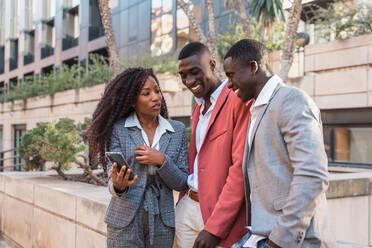 Cheerful black woman speaking on phone · Free Stock Photo