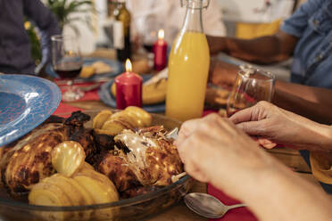 Hands of woman eating meat at dining table - JCCMF10614