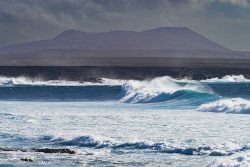 Spain, Canary Islands, Waves splashing near coast of Lanzarote island - WGF01468