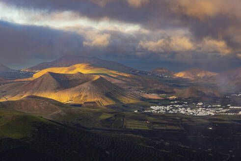 Spain, Canary Islands, La Geria, View from Montana de Guardilama volcano at cloudy dawn - WGF01480