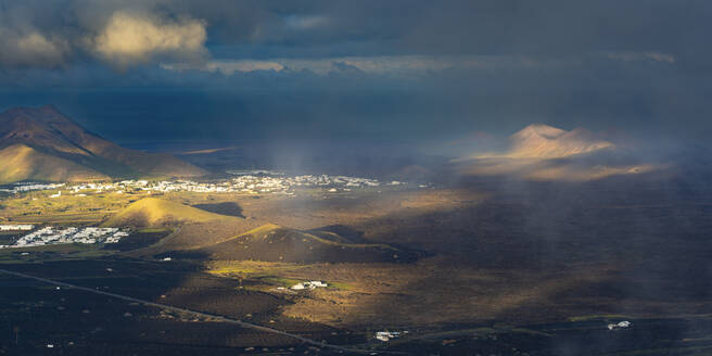 Spain, Canary Islands, La Geria, View from Montana de Guardilama volcano at cloudy dawn - WGF01482