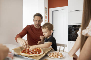 Father and son preparing pizza at home - SANF00123