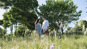 Couple standing in park at sunny day - ASGF03886