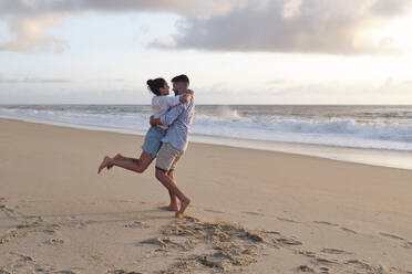 Boyfriend and girlfriend enjoying together at beach - ASGF03950