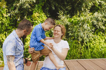 Happy family spending leisure time on footbridge - IHF01538