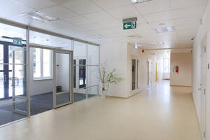 A modern school building, a wide corridor and hallway, light and airy, glass doors. - MINF16644