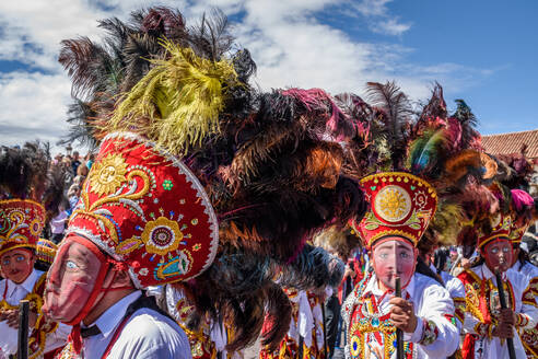 Cusco, a cultural fiesta, people dressed in traditional colourful costumes with masks and hats with feathers. - MINF16683