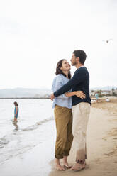 Happy couple embracing each other at beach - JOSEF19986