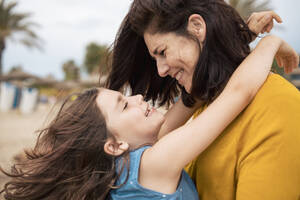 Happy mother and daughter having fun together at beach - JOSEF20111