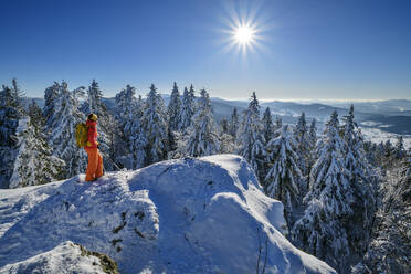 Mature woman hiking on snow covered mountain - ANSF00449