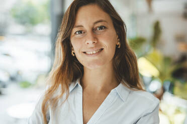 Smiling young woman in cafe - JOSEF20303