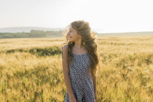 Cheerful girl with tousled hair in wheat field - AAZF00801