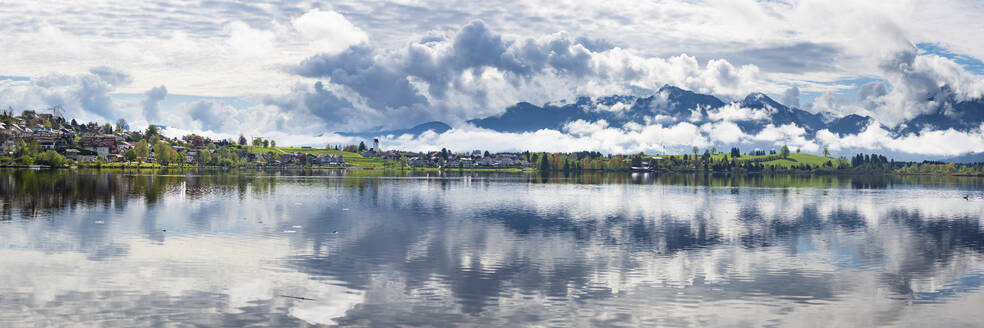 Germany, Bavaria, Hopfen am See, Panoramic view of clouds reflecting in Hopfensee lake - WGF01487