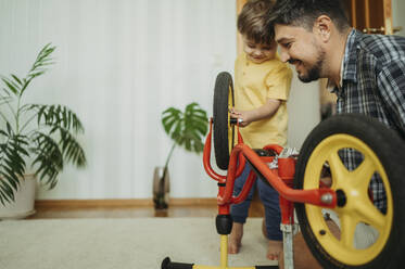 Sohn lernt zu Hause Fahrrad zu reparieren - ANAF01807