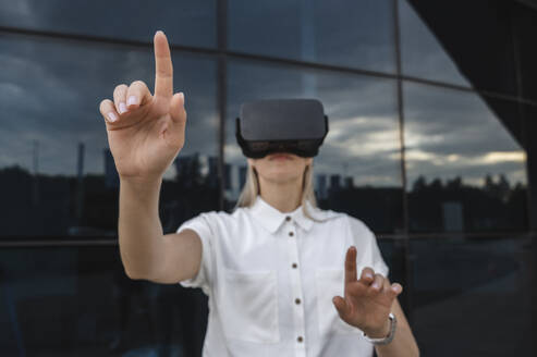 Businesswoman gesturing with virtual reality simulator - ALKF00465