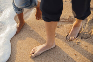 Couple walking barefoot at beach - JOSEF20345
