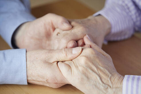 Close-up of senior couple holding hands - RBF09117