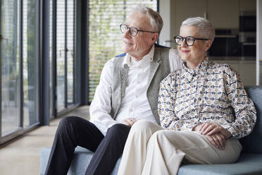 Senior couple sitting on couch at home - RBF09160