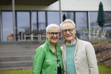 Portrait of senior couple in front of their home - RBF09252