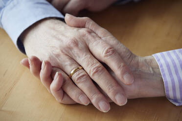 Close-up of senior couple holding hands - RBF09269