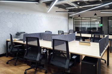 Chairs and desk arranged in modern office - PGF01486