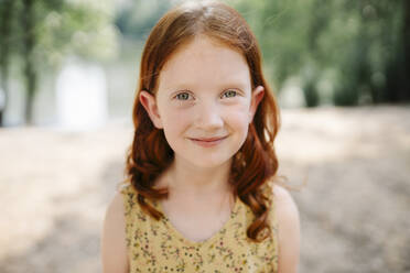 Happy redhead girl in park - SSYF00183