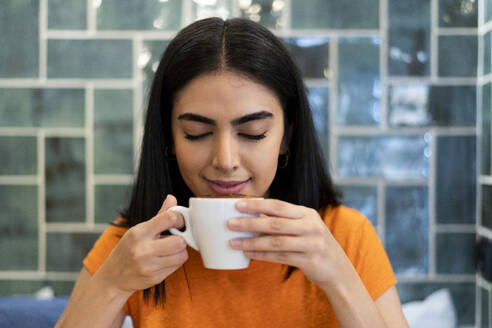 Young woman having coffee in cafe - LMCF00483