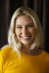 Portrait of happy blond woman smiling - EBSF03714