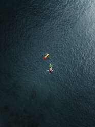Aerial view of people kayaking in the middle of nowhere near Phuket, Thailand. - AAEF19434