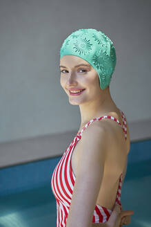 Smiling woman wearing swimwear by hot tub at spa - EKHF00046