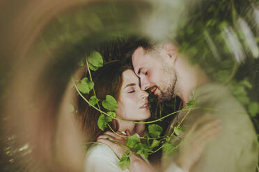 Romantic couple hugging near plants - YTF00916