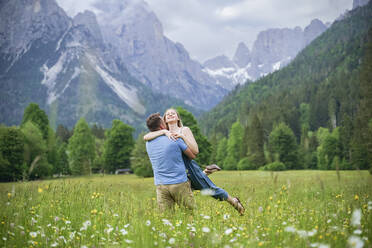 Man and woman enjoying vacation in front of mountains - NJAF00511