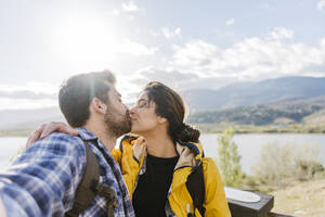 Romantic couple kissing each other on vacation - JJF00978