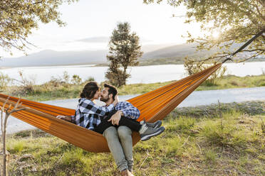 Affectionate couple relaxing in hammock - JJF01056