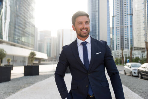 Handsome caucasian businessman - Portrait of a businessman walking outdoors - DMDF00666