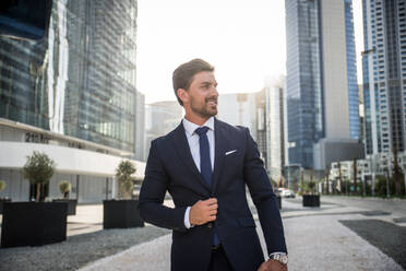 Handsome caucasian businessman - Portrait of a businessman walking outdoors - DMDF00667