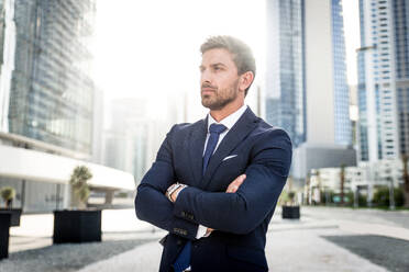 Handsome caucasian businessman - Portrait of a businessman walking outdoors - DMDF00672