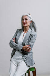 Schöne ältere Frau posiert auf einem Corporate Business-Foto-Session. Geschäftsfrau mit eleganten Anzug auf farbigen Hintergründen im Studio. - DMDF00785